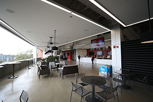 Seating arranged in the concourse with a bar in the background