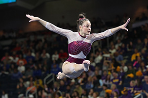 Gabby Gladieux jumping on the beam