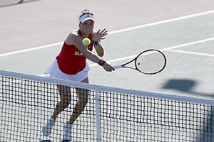 women's tennis player hitting ball